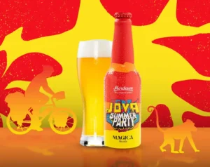 Bottle of Java Summer Party beer beside a glass, set against a bright yellow–red abstract background with cyclist and monkey silhouettes.